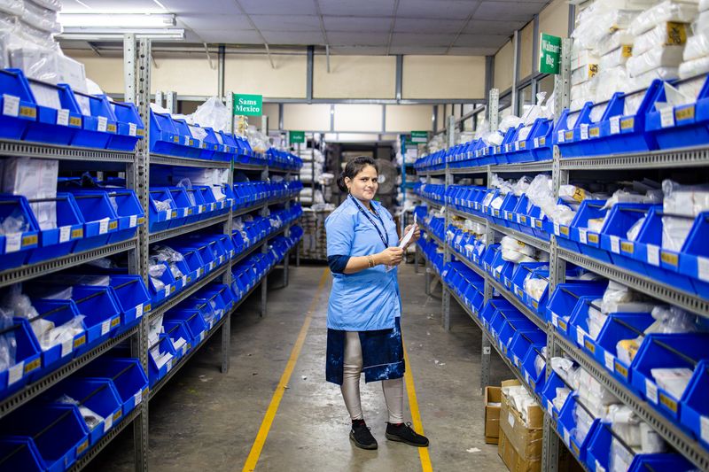 A warehouse worker in an aisle of an industrial storage facility